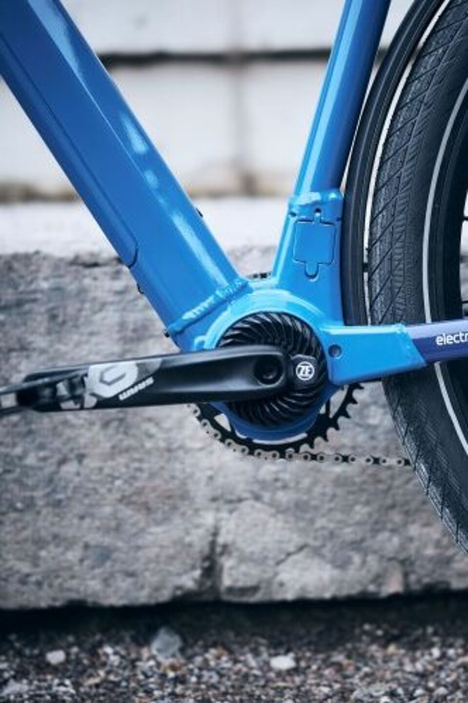 ZF Eurobike Tretlagerbereich eines blauen Fahrrads mit einem dosenförmigen Elektroantrieb.